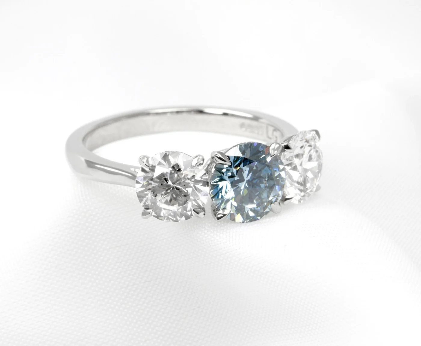 Timothy Roe Laboratory-Grown Diamond Three Stone Ring in Platinum. Three round brilliant cut laboratory-grown diamonds centre: 1.41ct fancy vivid blue. Sides: 1.00ct, D, VVS2.