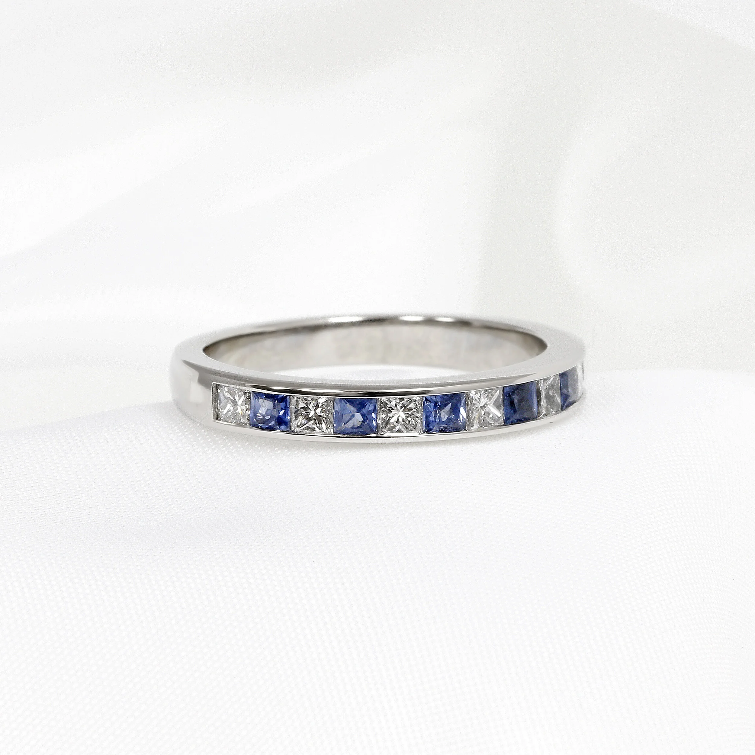 Blue Sapphire and Diamond Half Eternity Ring in Platinum