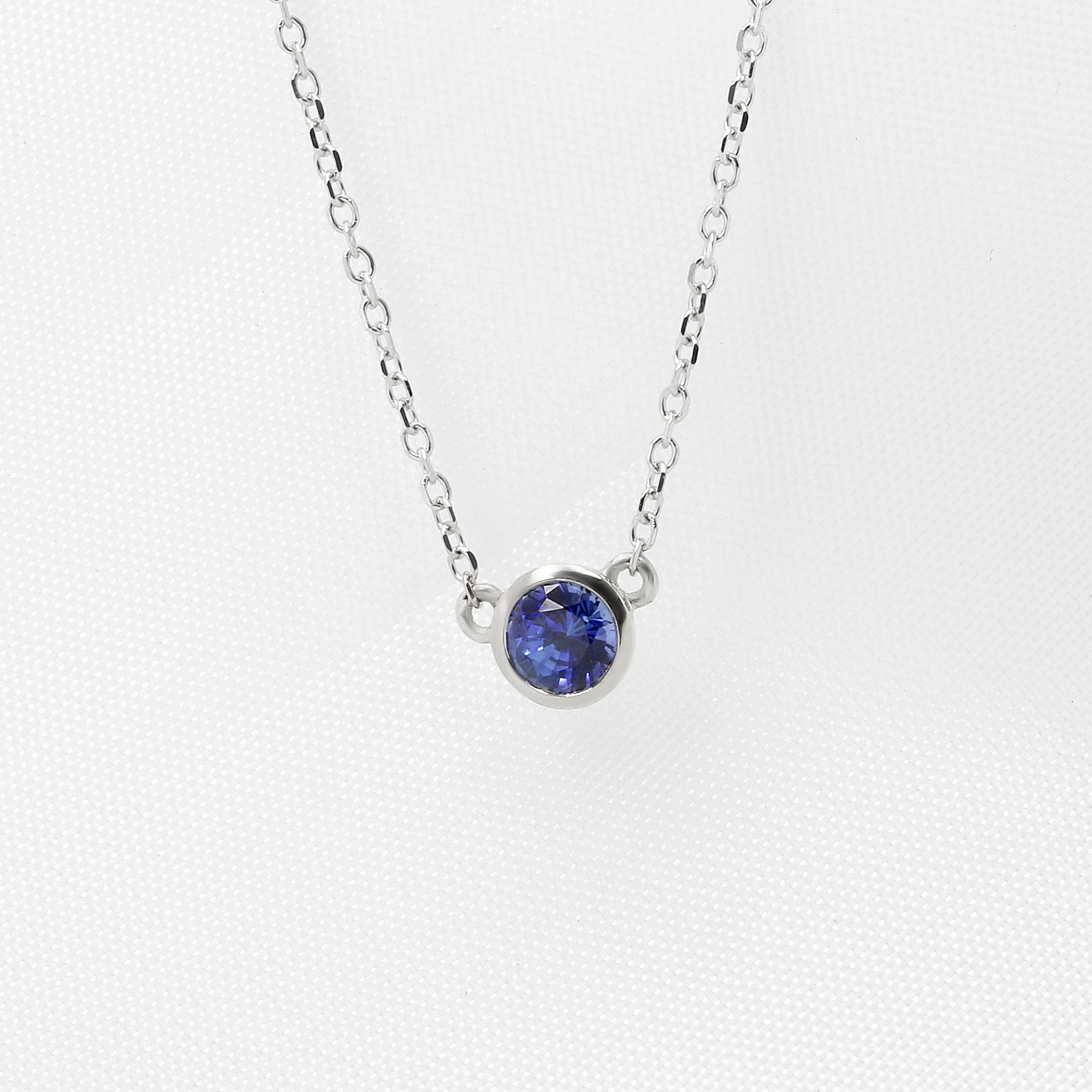 Rub Over Set Blue Sapphire Pendant in White Gold.