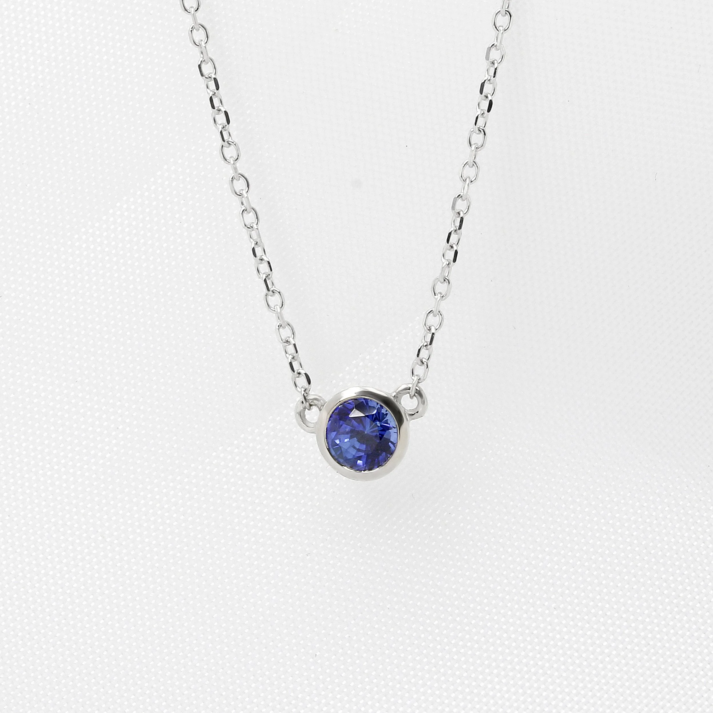 Rub Over Set Blue Sapphire Pendant in White Gold.