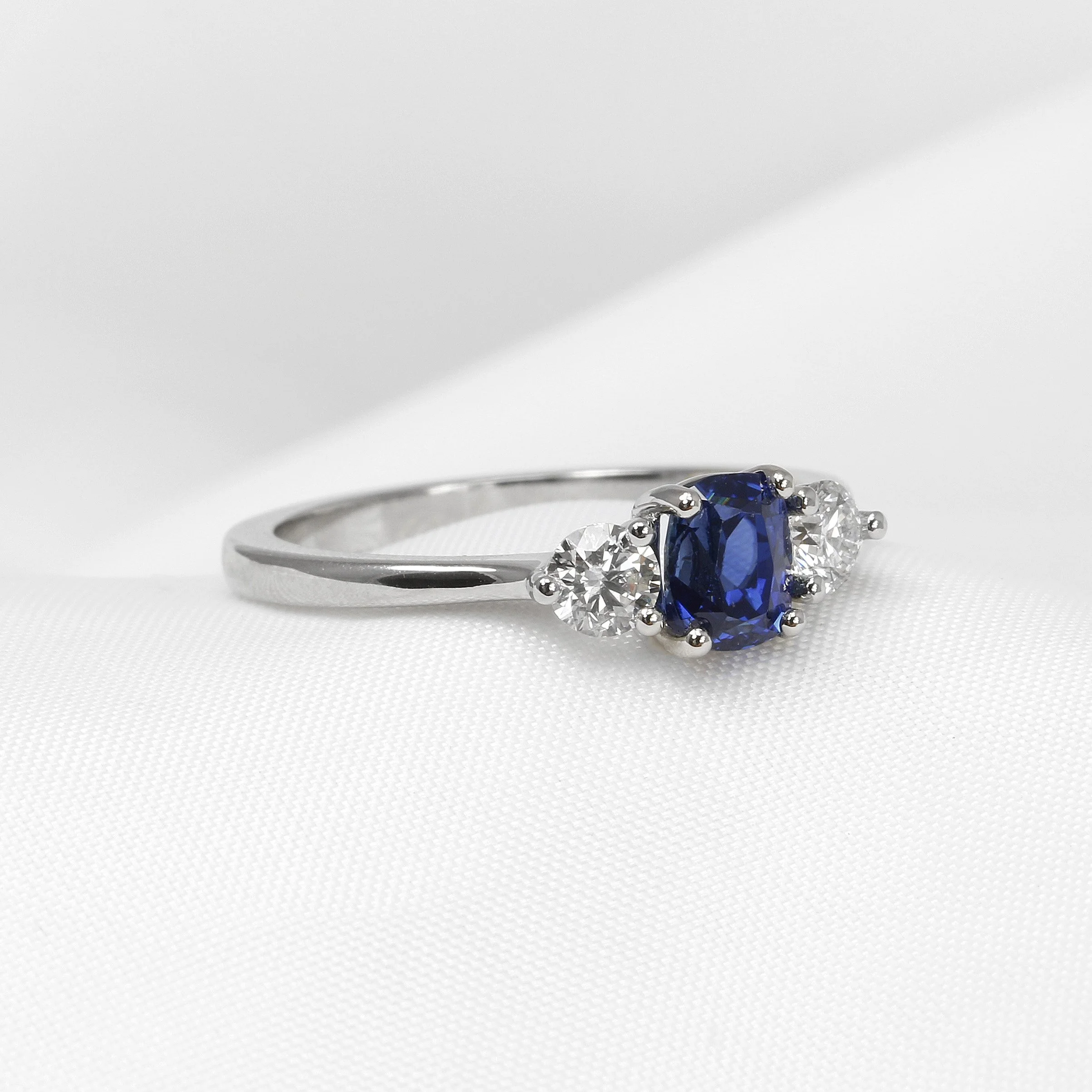 Cushion Sapphire and Diamond Three Stone Ring in Platinum