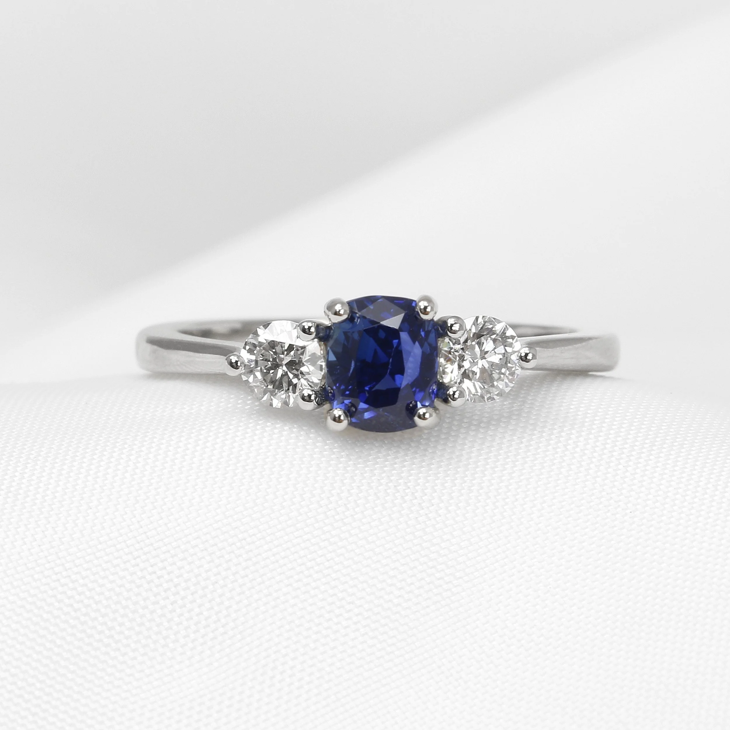 Cushion Sapphire and Diamond Three Stone Ring in Platinum