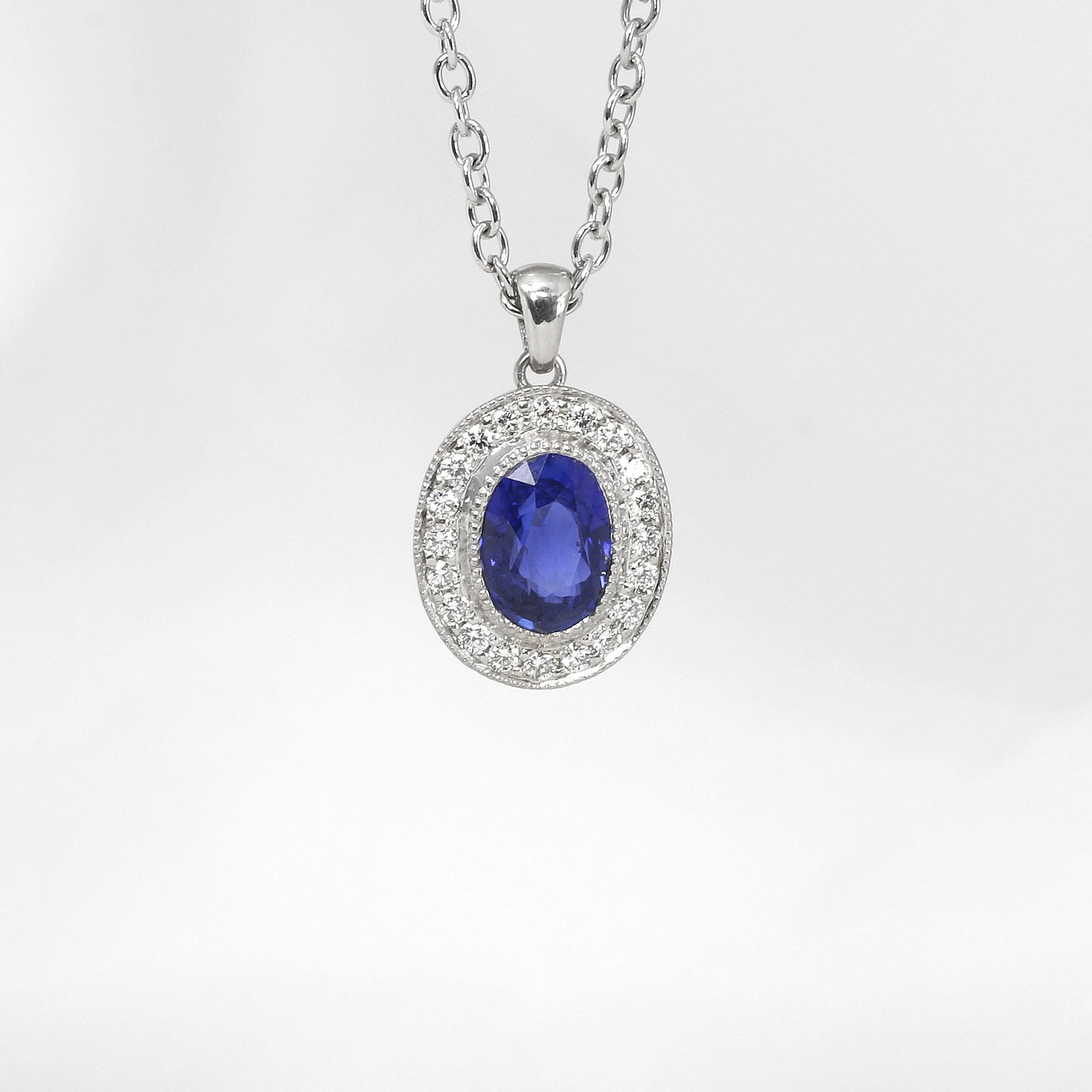 Sapphire and Diamond Halo Pendant in White Gold
