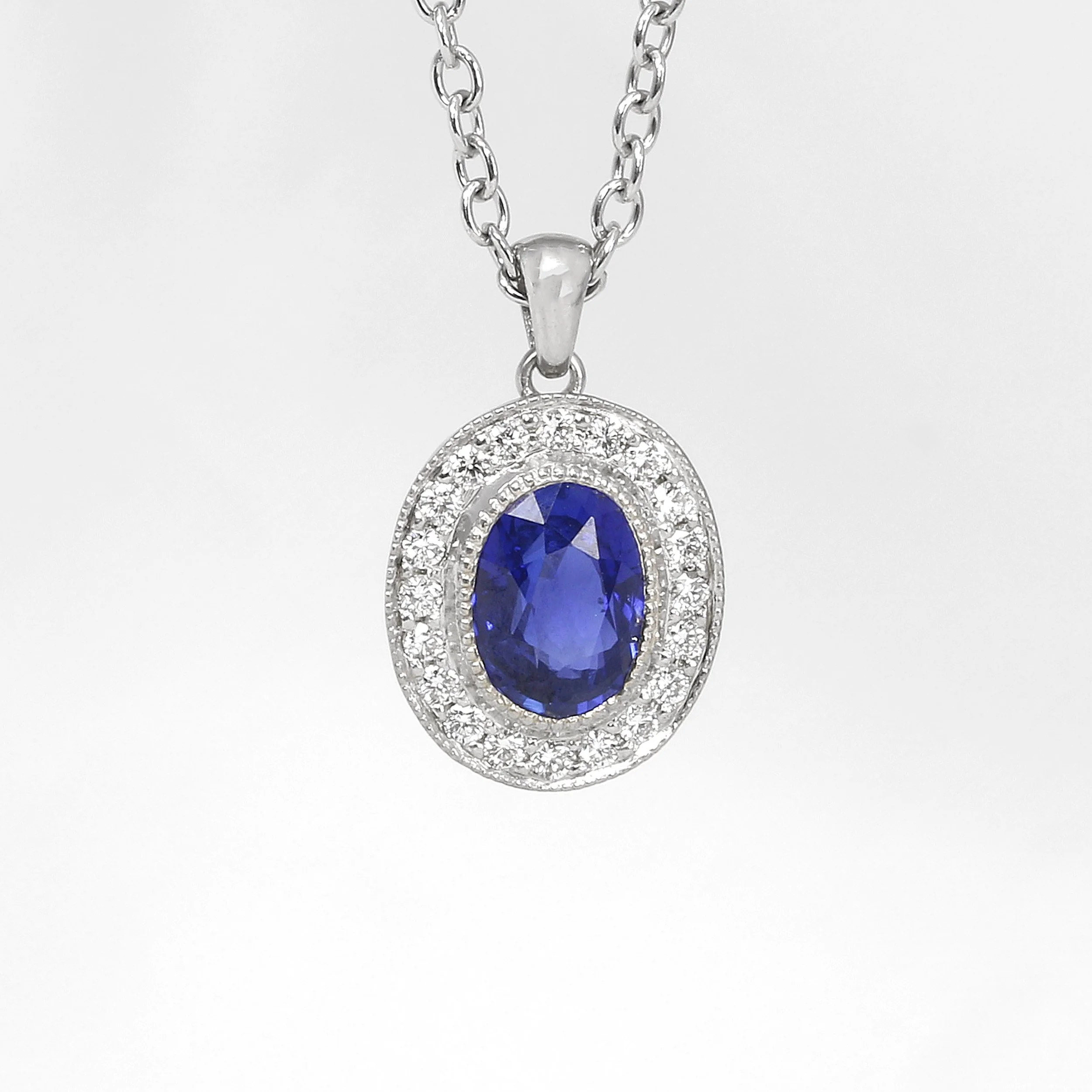 Sapphire and Diamond Halo Pendant in White Gold