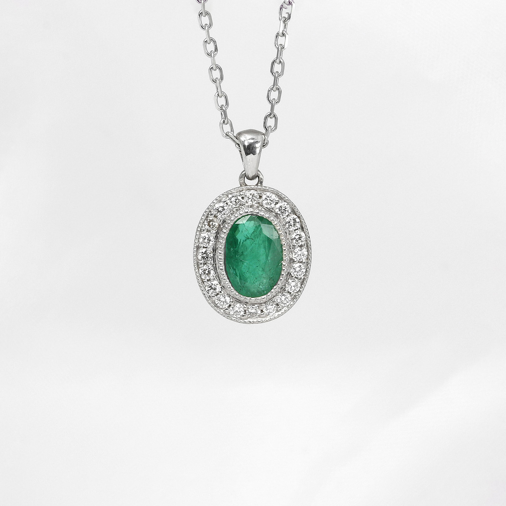 Emerald and Diamond Halo Pendant in White Gold