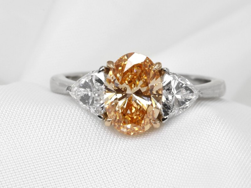Laboratory Created Orange Oval and Trilliant Cut Diamond Three Stone Ring