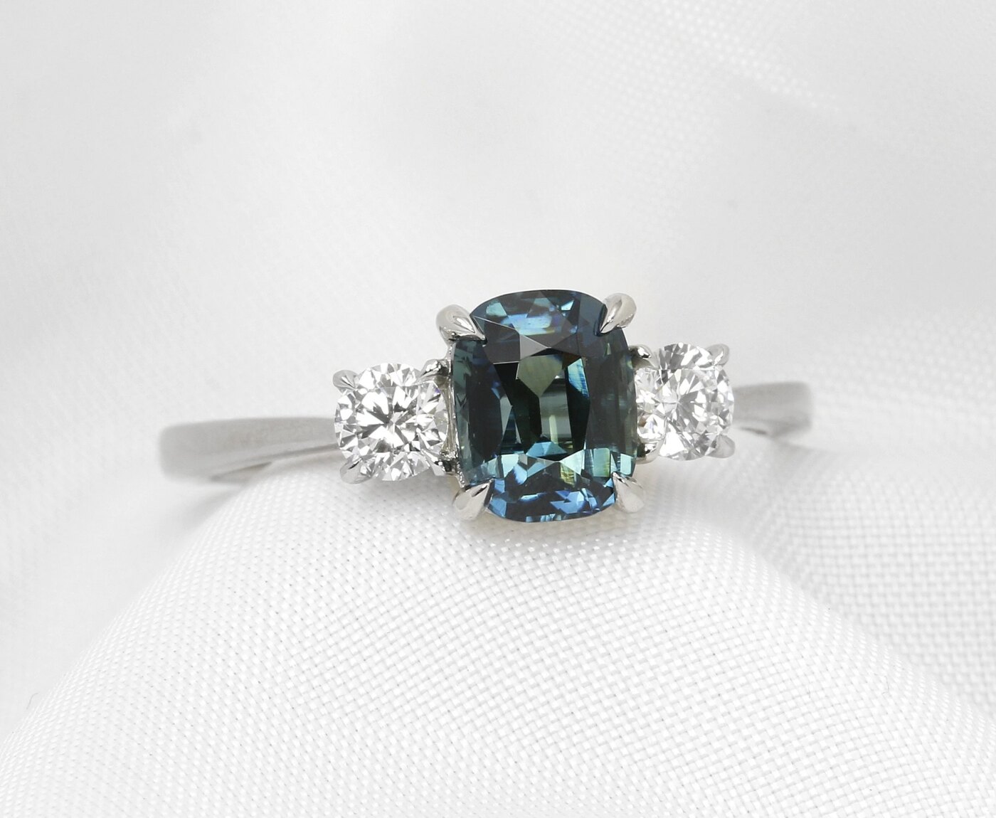 Cushion Teal Sapphire and Diamond Three Stone Ring in Platinum 