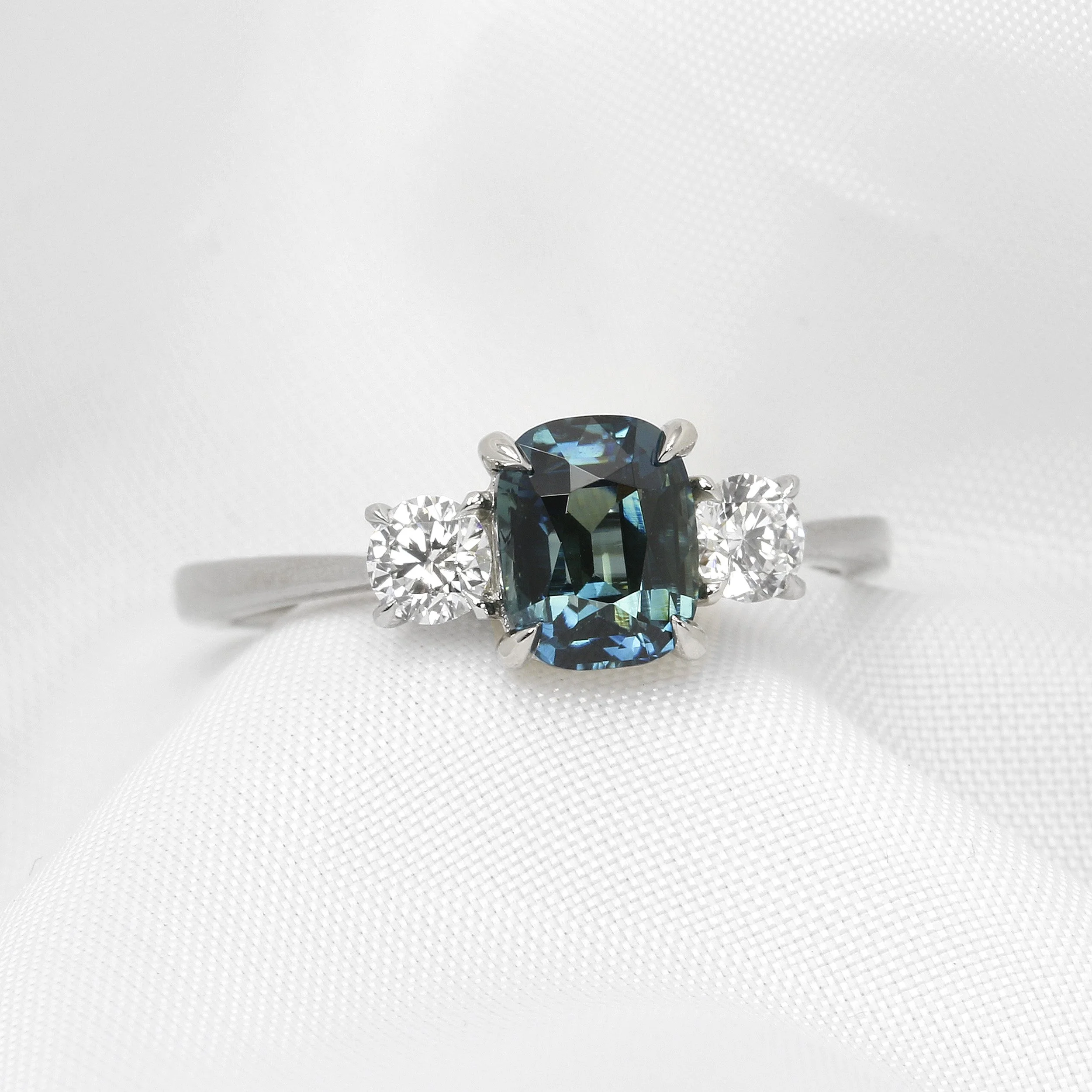 Cushion Teal Sapphire and Diamond Three Stone Ring in Platinum