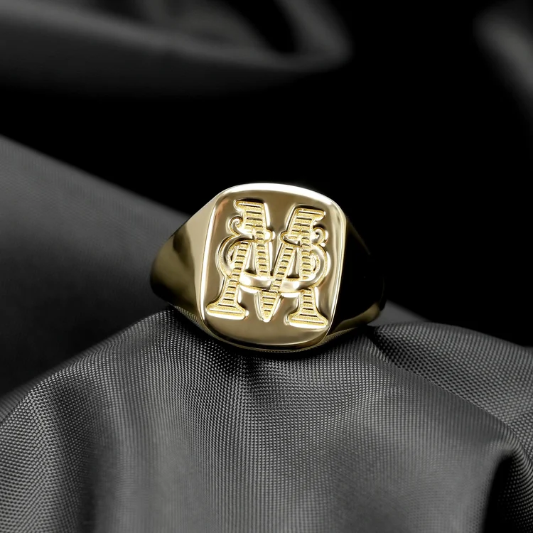 gold signet ring engraved with M