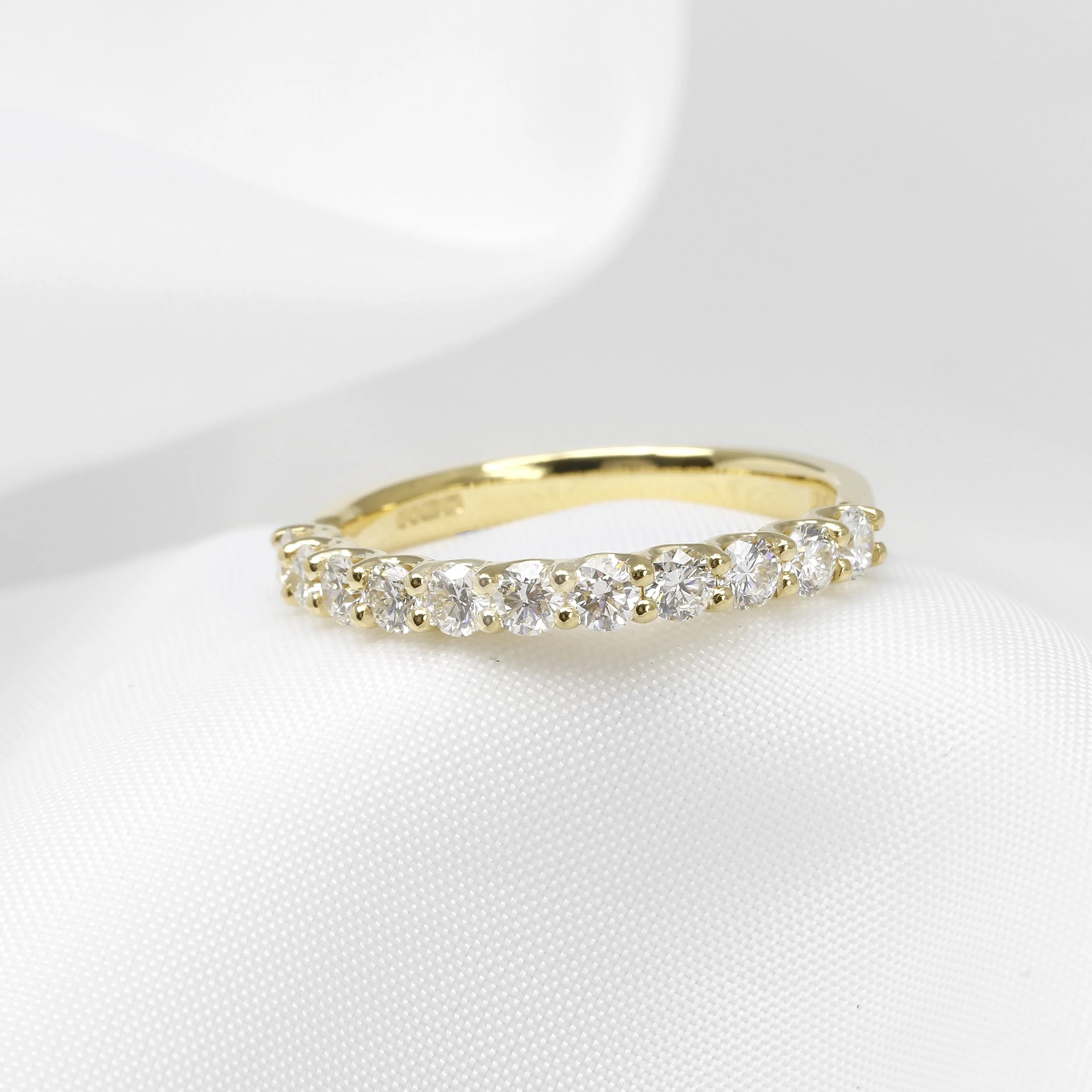 Diamond eternity ring in yellow gold shared claw