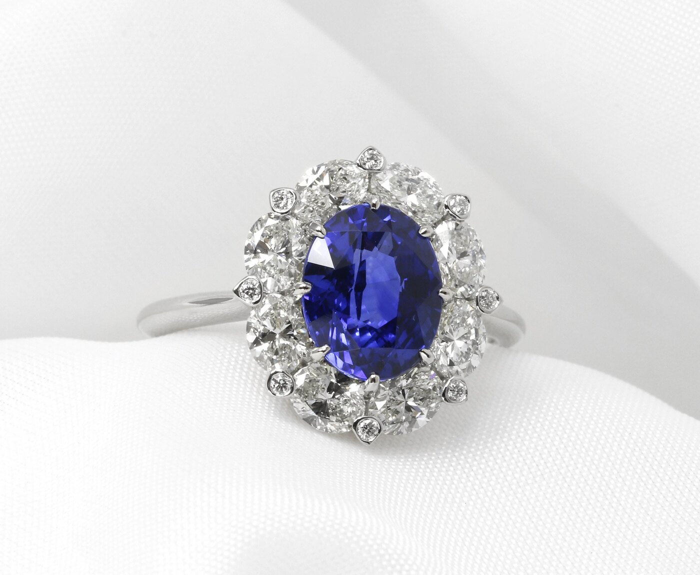 Oval Sapphire and Diamond Bordered Cluster Ring in Platinum 
