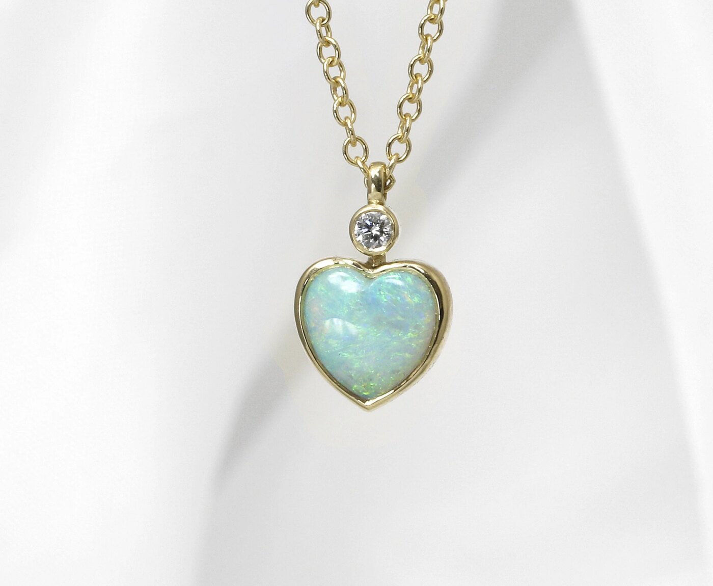 Heart Shaped Opal and Diamond Pendant in Yellow Gold