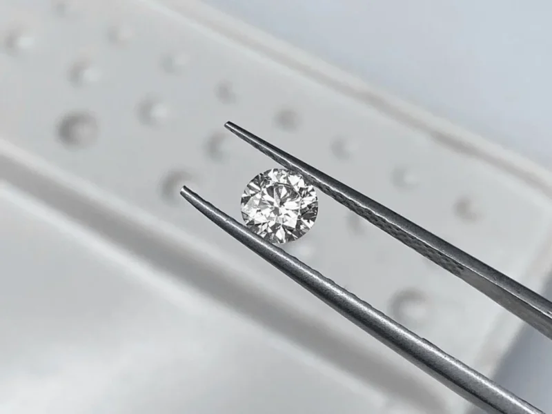 Loose diamond in tweezers