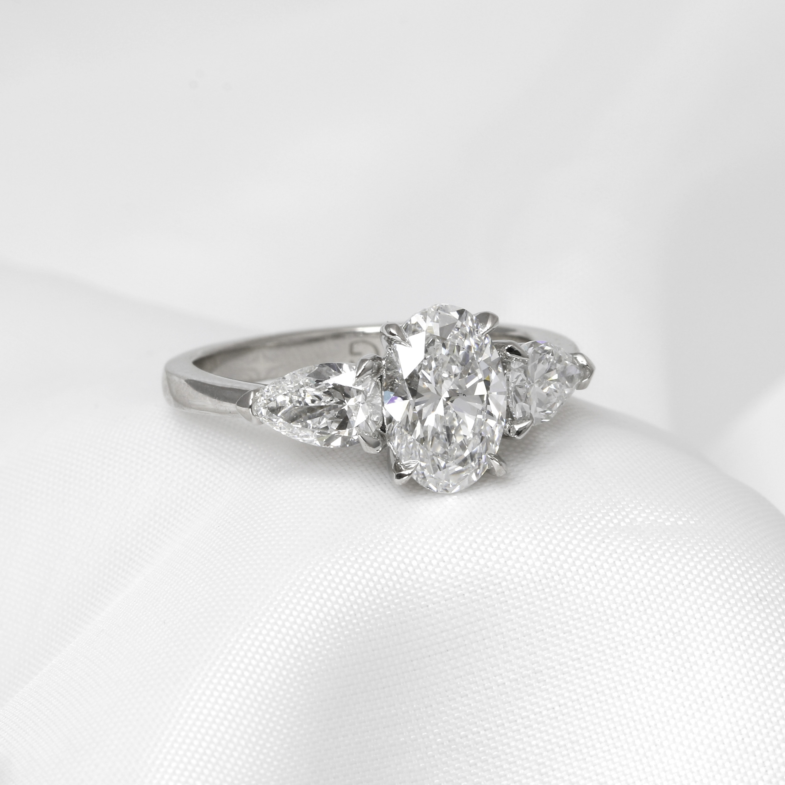 Laboratory Created Oval and Pear Three Stone Diamond Ring