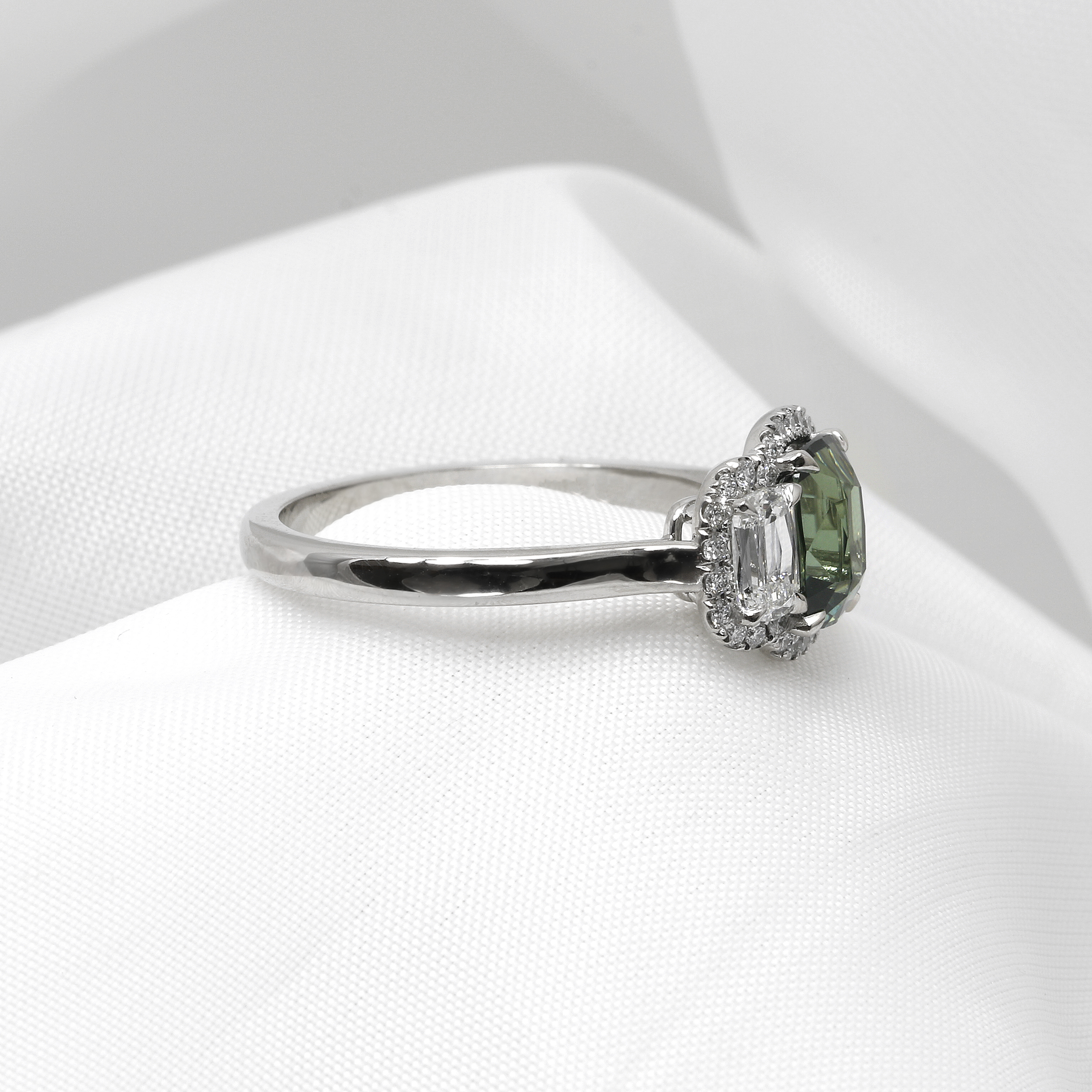 Teal Sapphire and Diamond Halo Three Stone Ring in Platinum