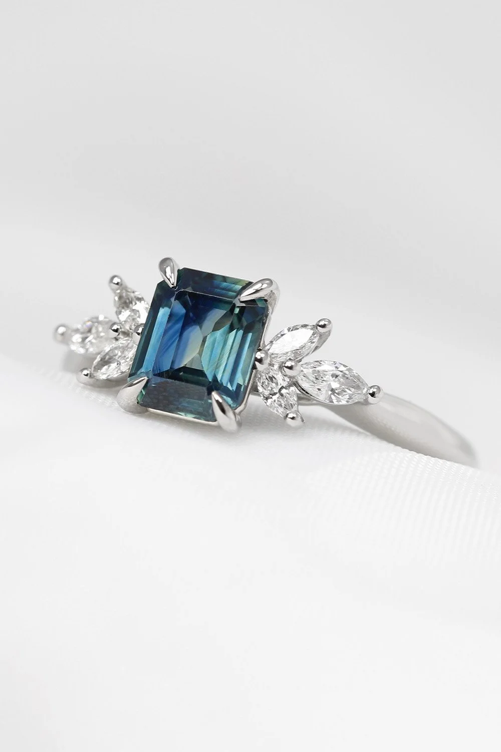 December 2021 - Teal Sapphire with Marquise Diamonds in Platinum
