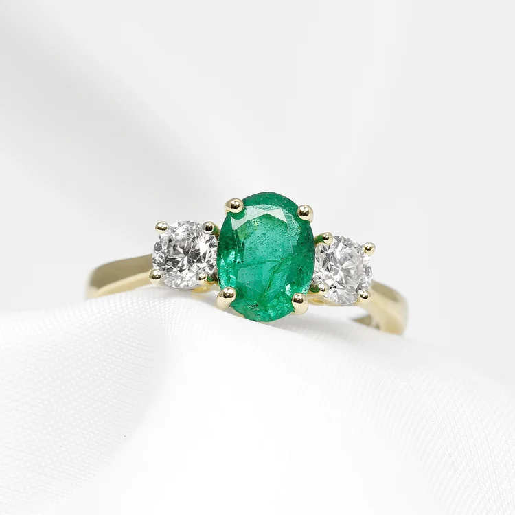 July 2023 - Oval Emerald and Round Diamonds in Yellow Gold