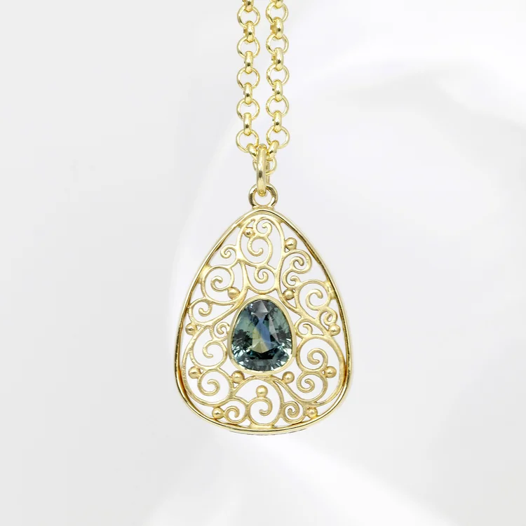 May 2024 - Teal Sapphire and Yellow Gold