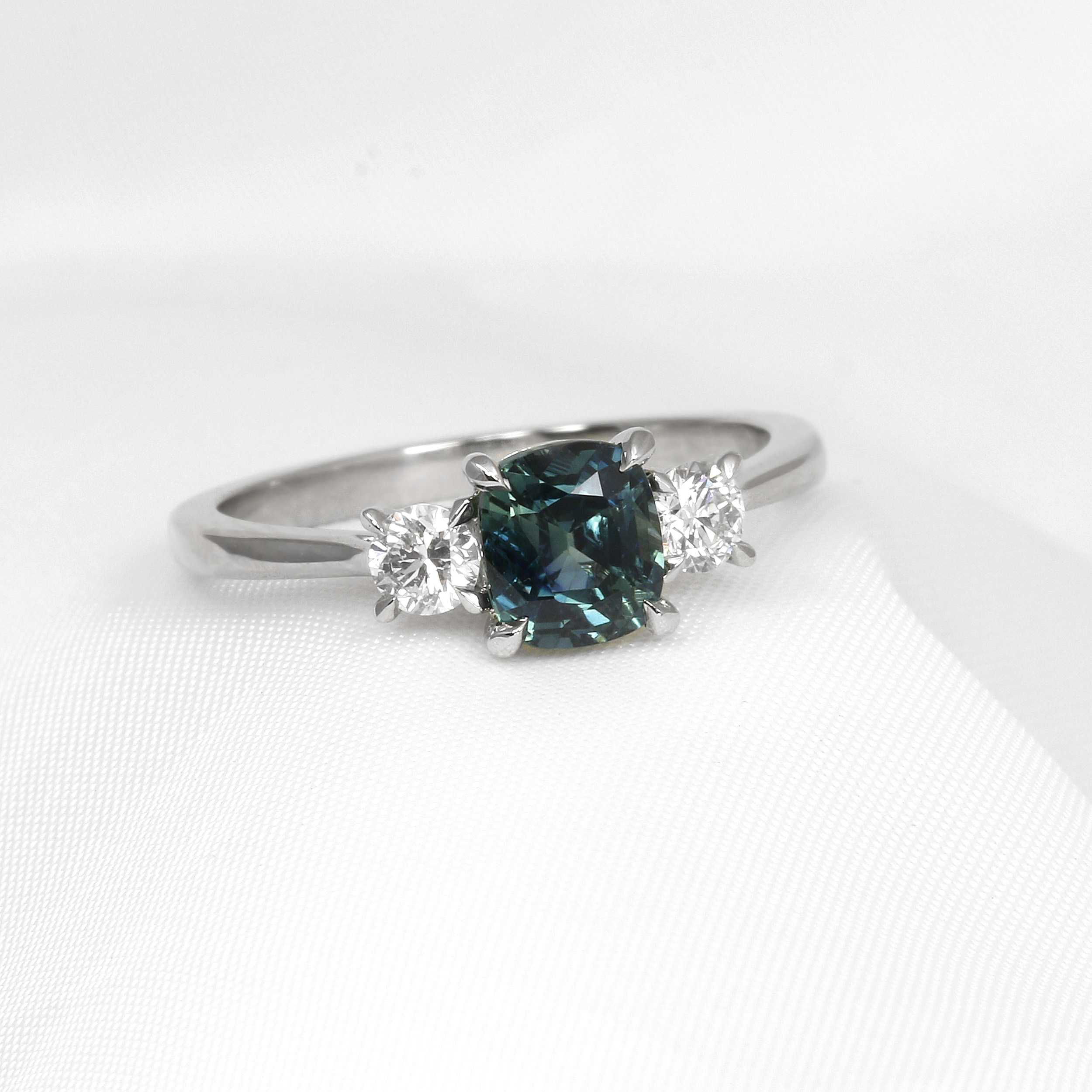 Cushion Teal Sapphire and Diamond Three Stone Ring in Platinum