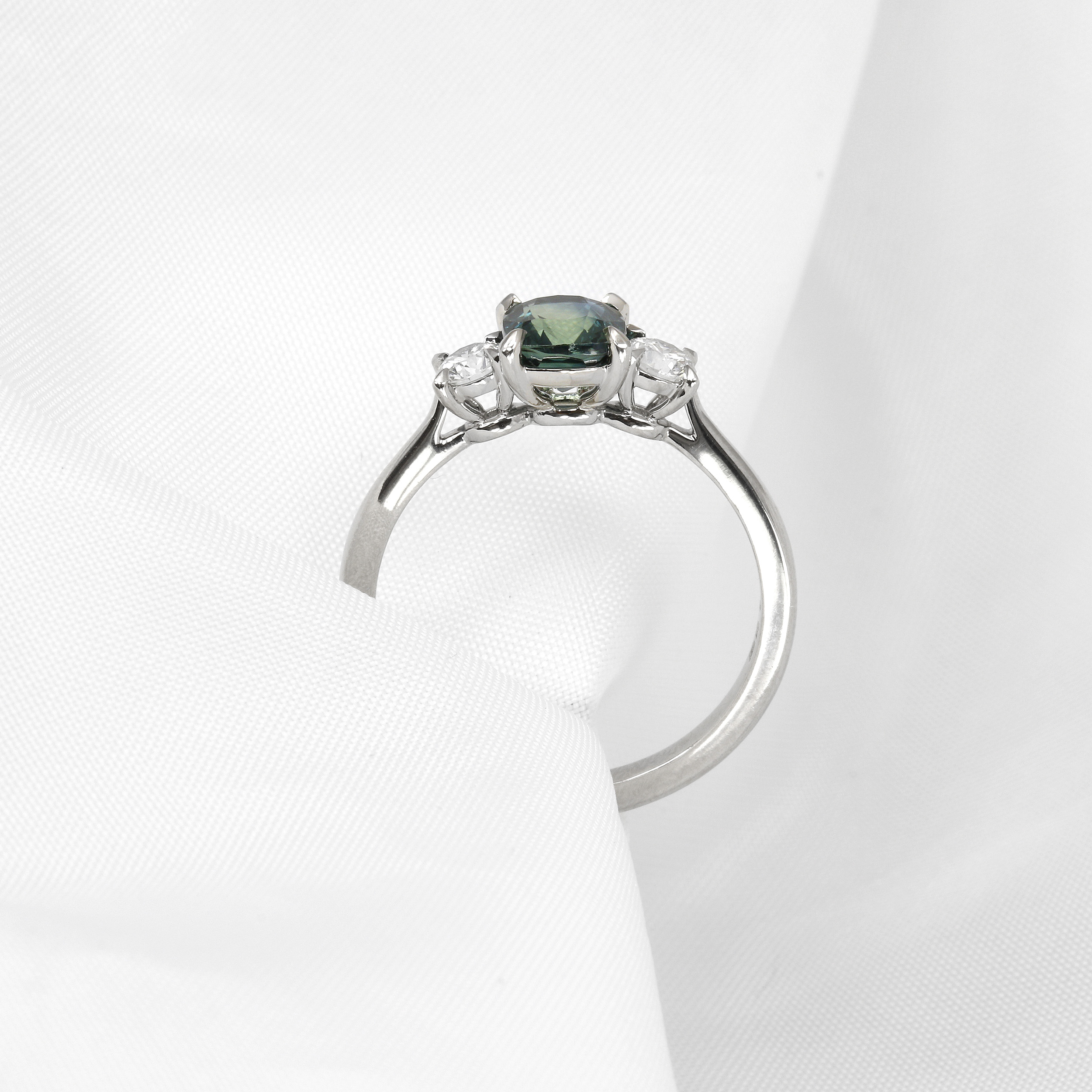 Cushion Teal Sapphire and Diamond Three Stone Ring in Platinum