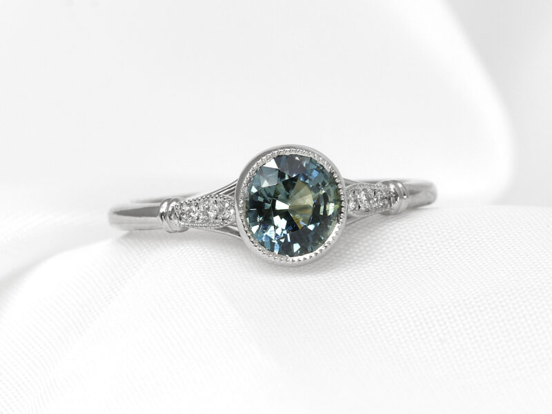 Teal Sapphire Solitaire Ring with Diamond Set Shoulders in Platinum