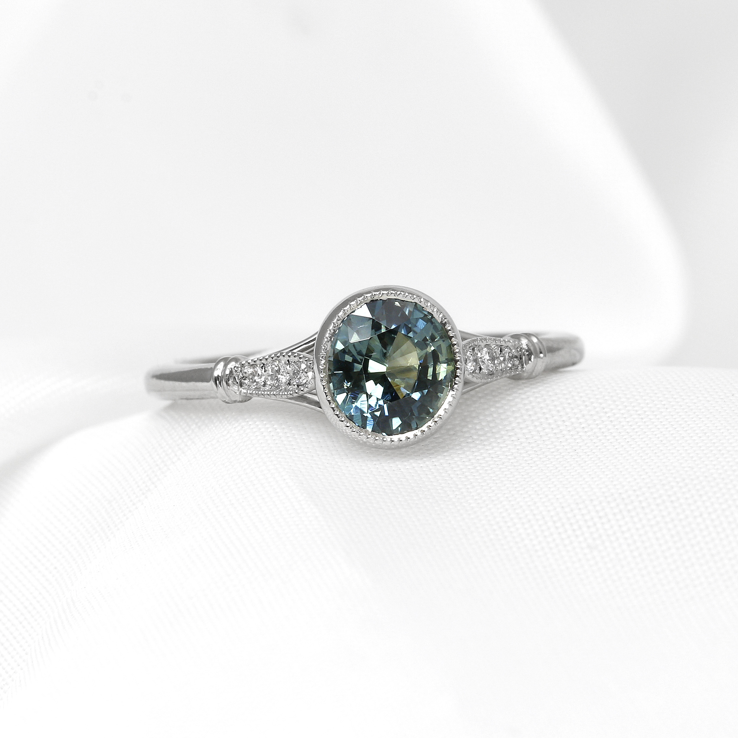 Teal Sapphire Solitaire Ring with Diamond Set Shoulders in Platinum