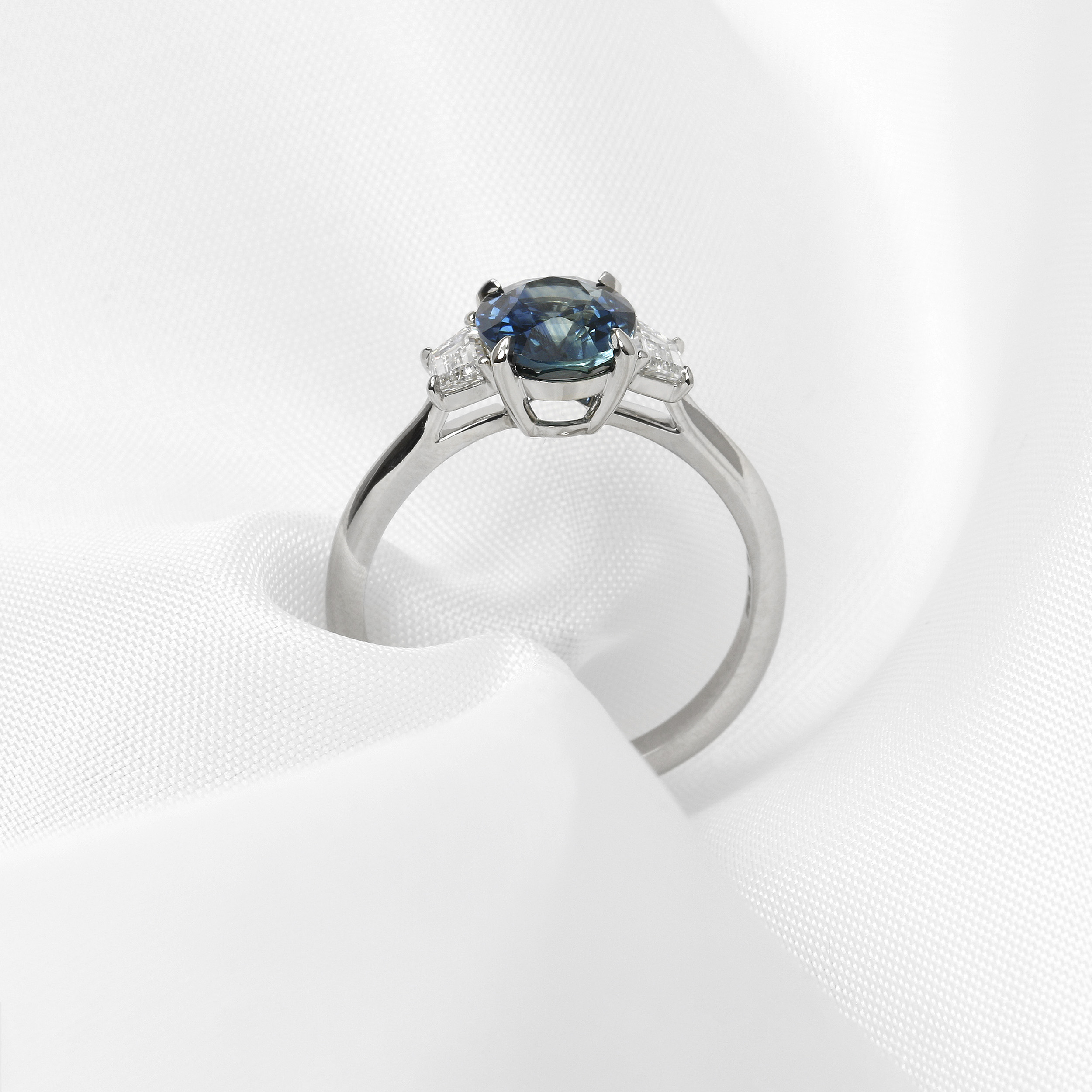 Oval Teal Sapphire and Diamond Three Stone Ring in Platinum